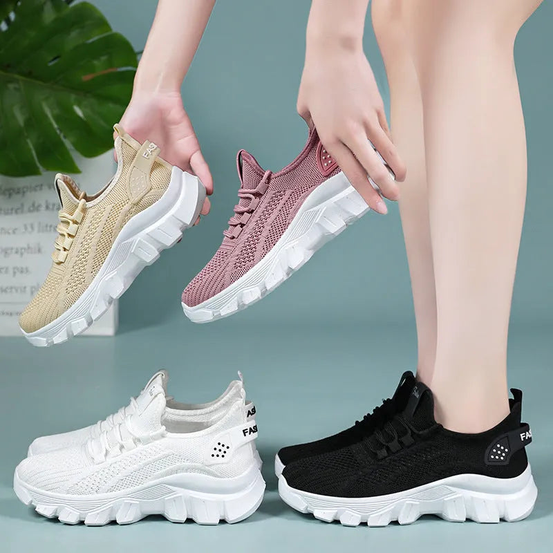 Women's white Flyknit sneaker with thick PVC sole and lace-up closure on a neutral background.