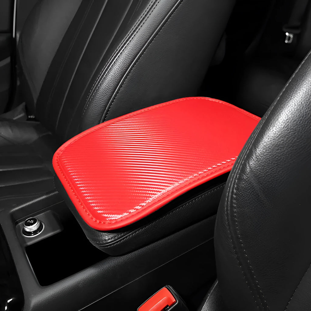 Automotive carbon fibre armrest box mat in black leather, 29x19cm, on a car centre console