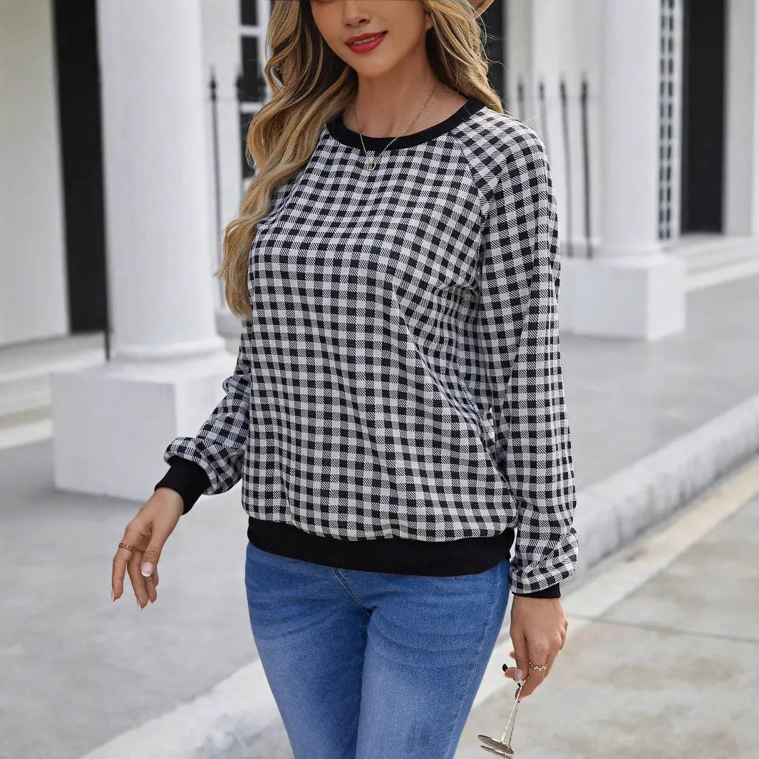 Black plaid pattern long sleeve polyester pullover sweater on a hanger.
