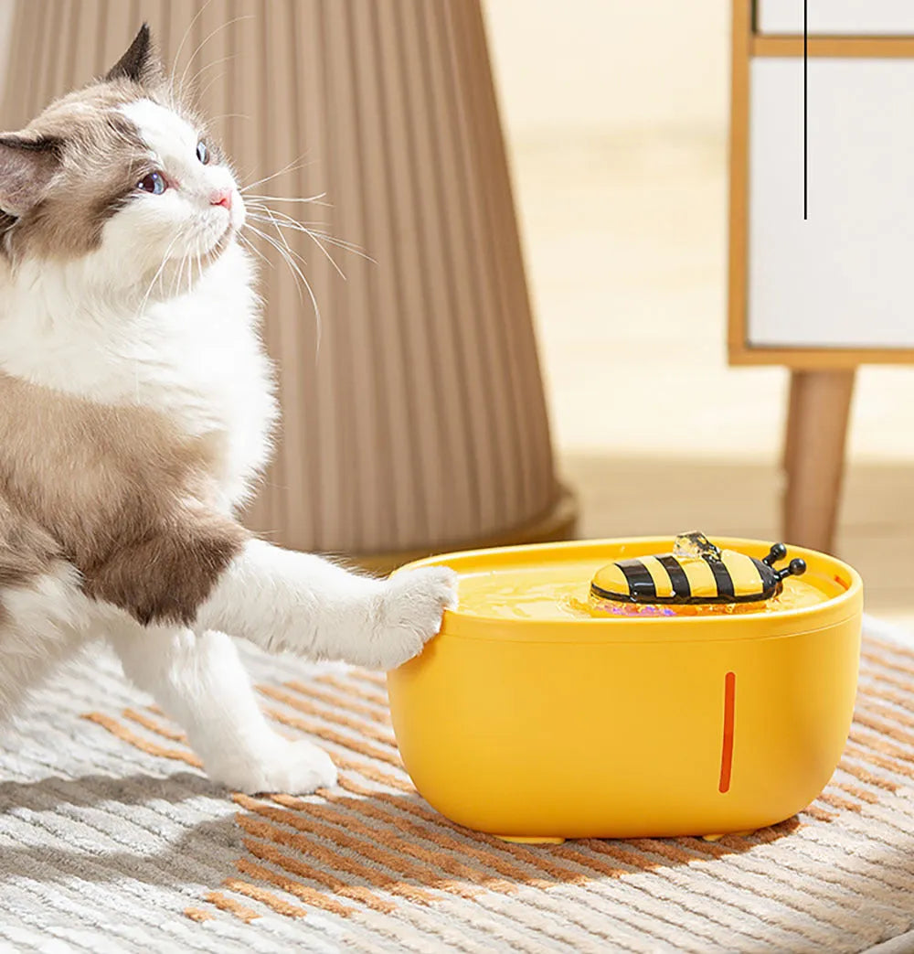 Yellow automatic cat water fountain with filter and silent USB pump on anti-slip base.