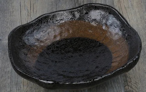 Japanese-style ceramic sashimi bowl with irregular shape and floral decoration