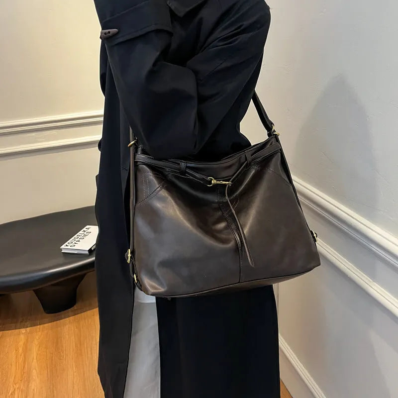 Retro large capacity PU tote bag in black with double shoulder straps and sewing line detail
