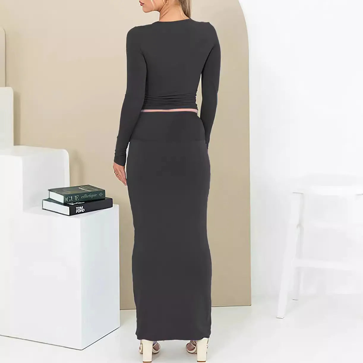 Women's sweet style two-piece suit with a cropped top and long skirt in polyester fabric.