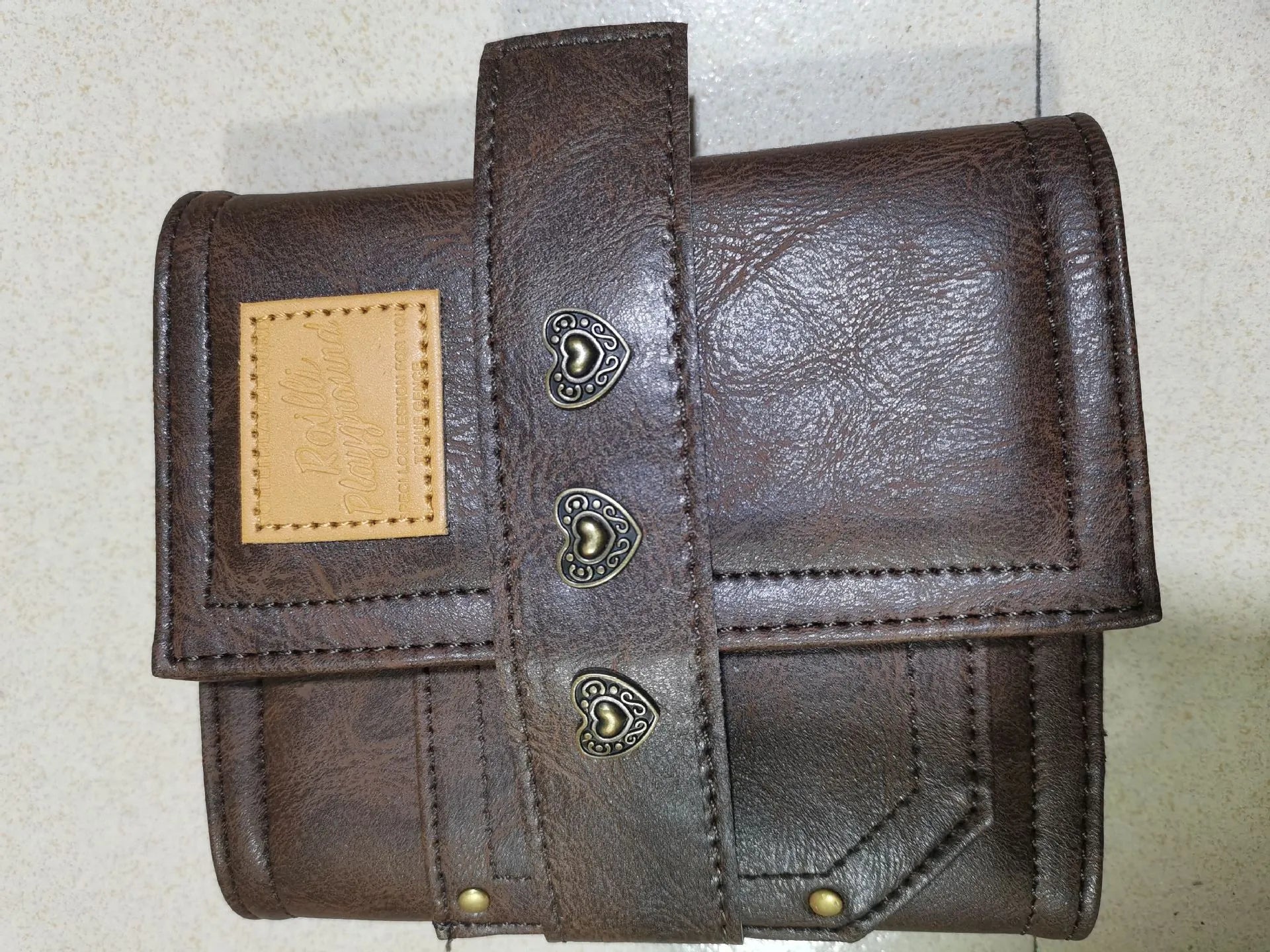 A7 brown PU leather notebook with buckle closure and loose-leaf binder binding