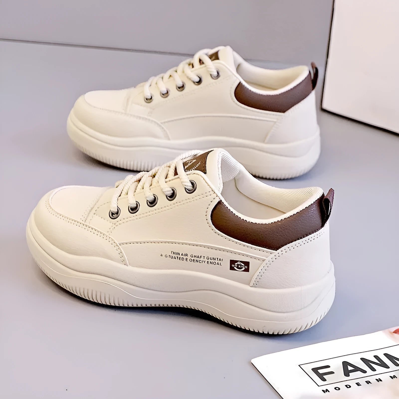 Women's white Korean-style low-top pumps with cross straps and lace-up front on a rubber sole.