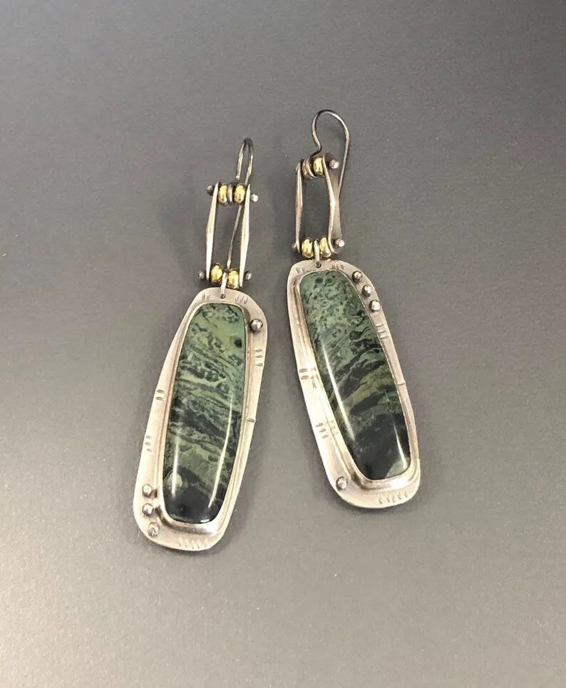 Geometric alloy earrings with two-tone marble pattern design on white background