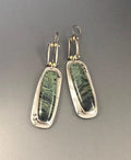 Geometric alloy earrings with two-tone marble pattern design on white background