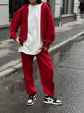 Street style loose fit two-piece set showing long-sleeved coat and matching trousers in solid colour