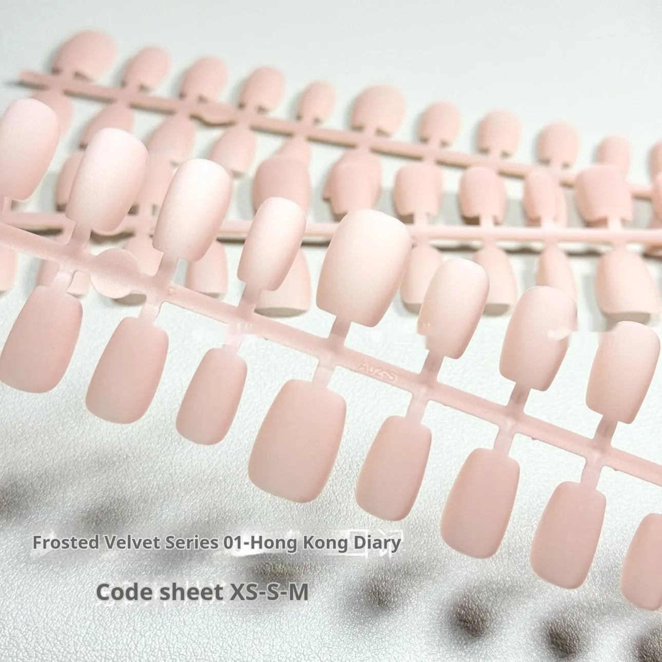 Frosted velvet Cat's Eye Aurora effect artificial nail set in short ladder sizes on a display card.