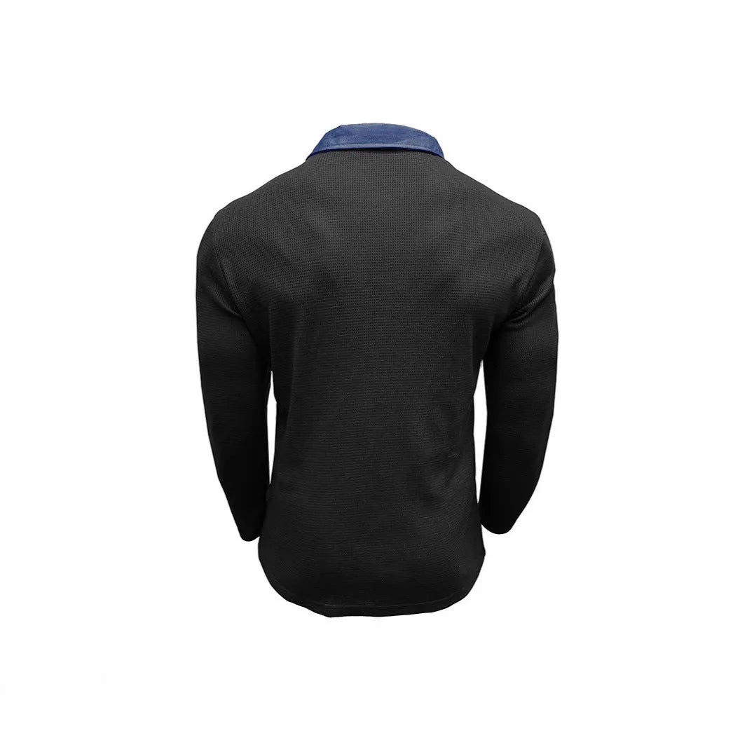 Man wearing a long-sleeved waffle-texture polo shirt in a solid colour with an asymmetric design detail.