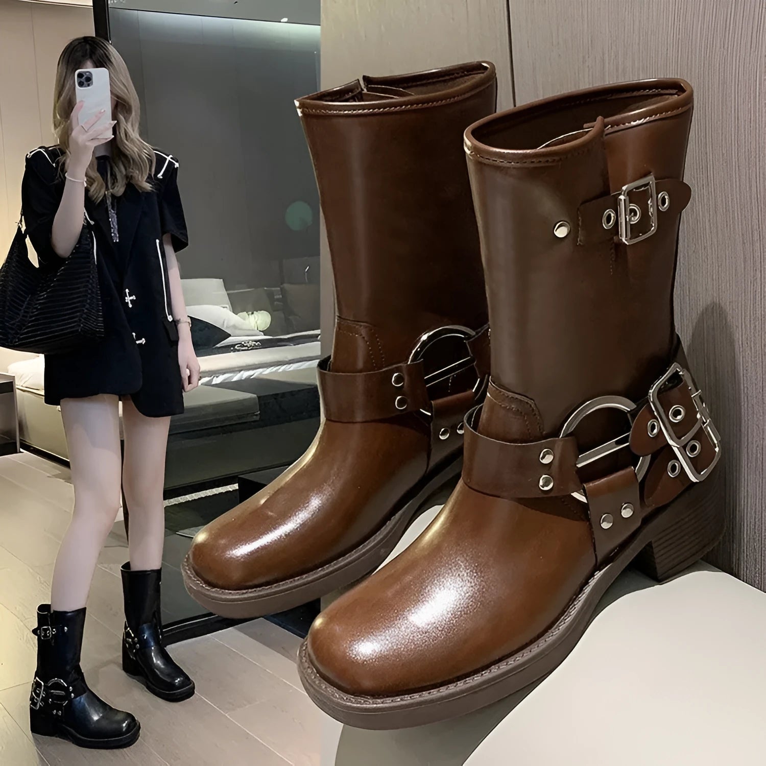 Black women's platform boots with a belt buckle detail on the shaft, shown in mid-calf length.