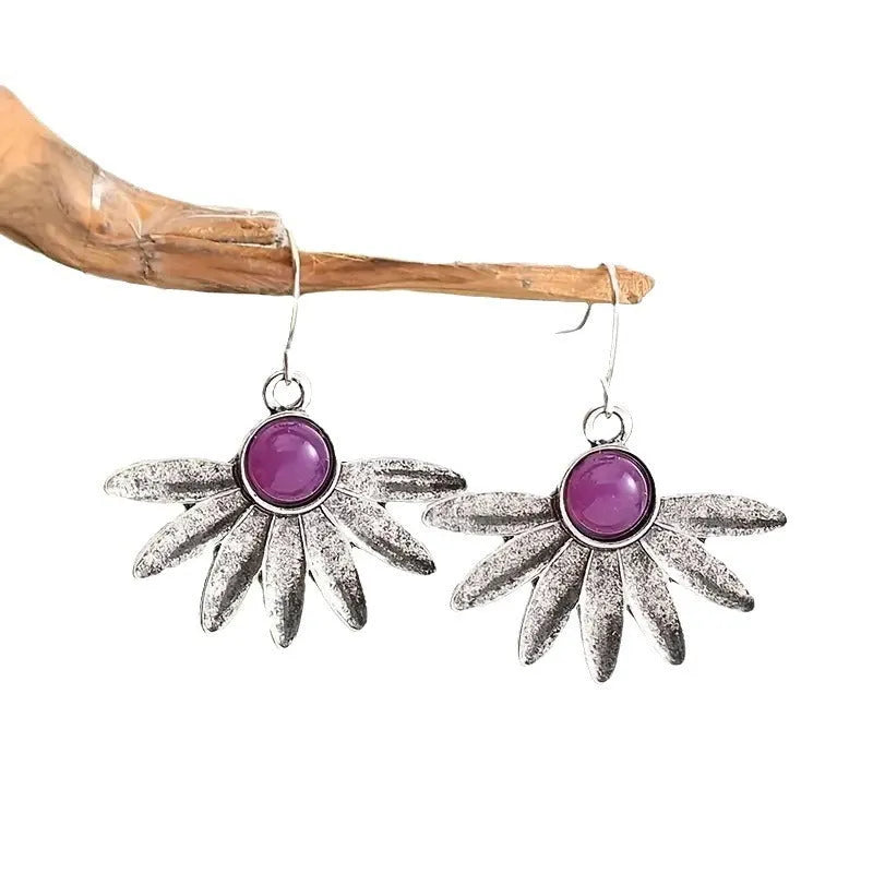 Purple resin bohemian earrings with animal zodiac design and floral elements on alloy settings