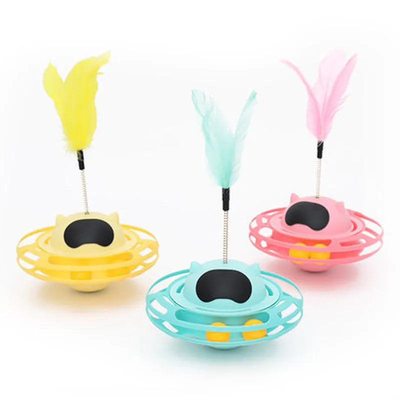 Pink plastic cat tumbler turntable stick toy with feather attachments on a white background.
