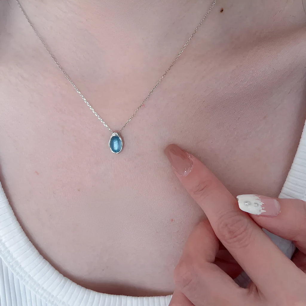 Women's navy blue water drop pendant necklace with geometric copper pendant and cross chain design