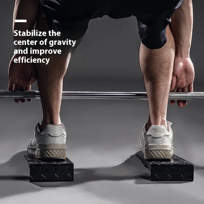 Black iron squat foot pad hard pull auxiliary force generator on gym floor