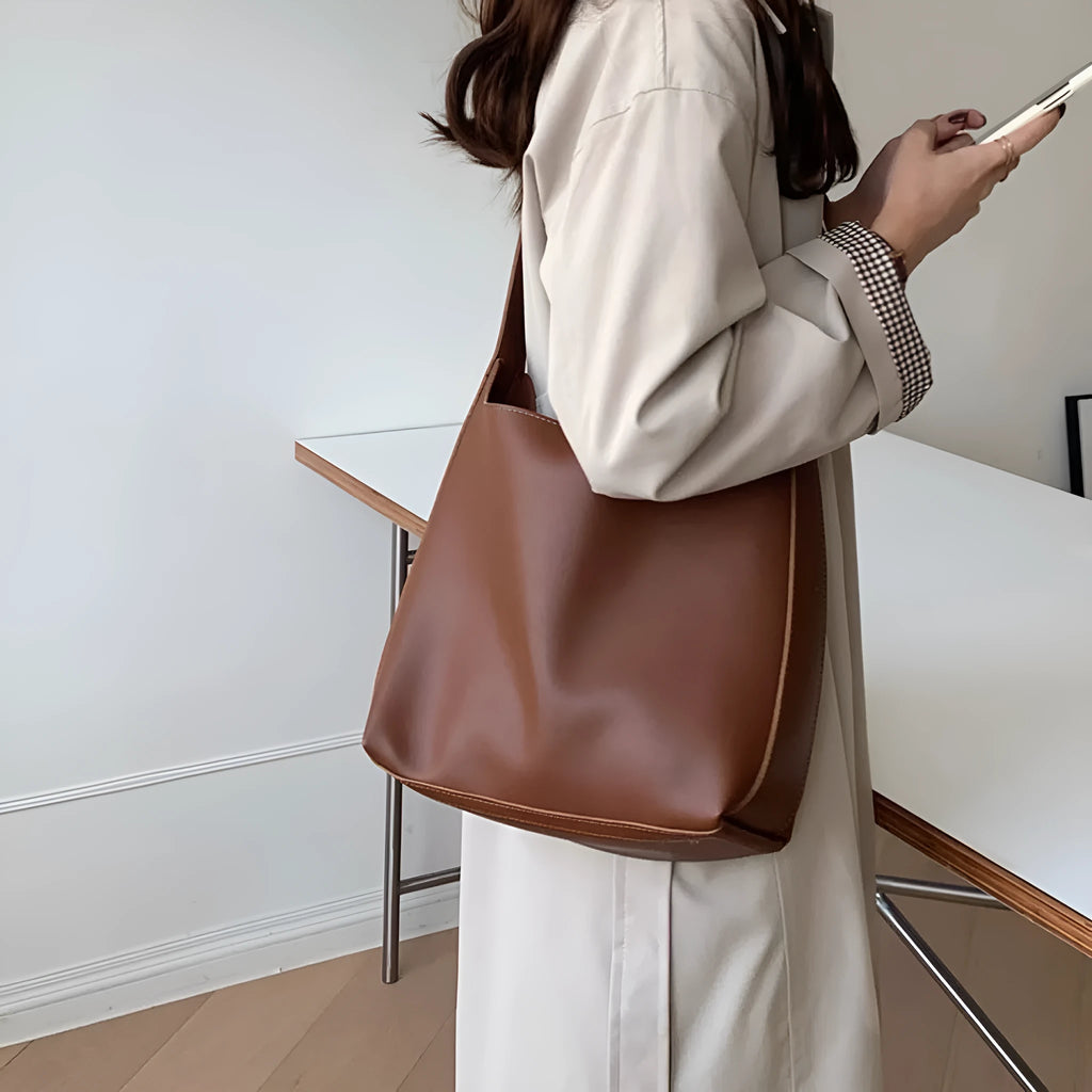 Women's soft PU leather shoulder bag with swing threads detail in black and brown colour options