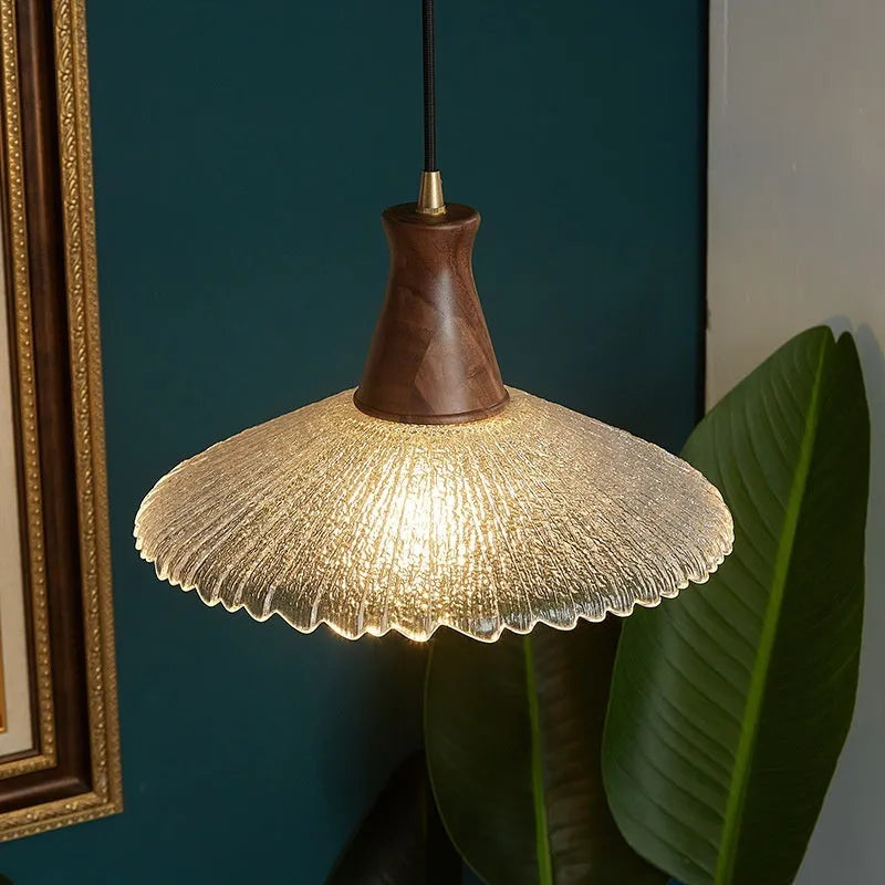 Retro-style brass and glass chandelier with a wooden frame hanging from a ceiling.