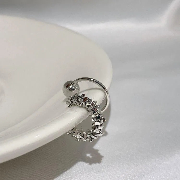 Pair of geometric-shaped alloy ear clips with a frosty finish and double clip mechanism.