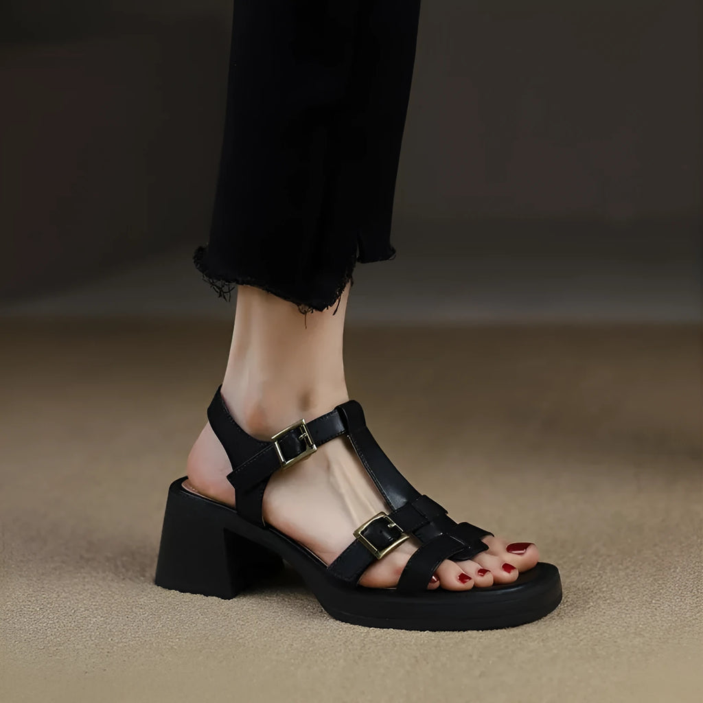Women's black retro platform sandals with a T-shaped buckle strap and chunky heel.