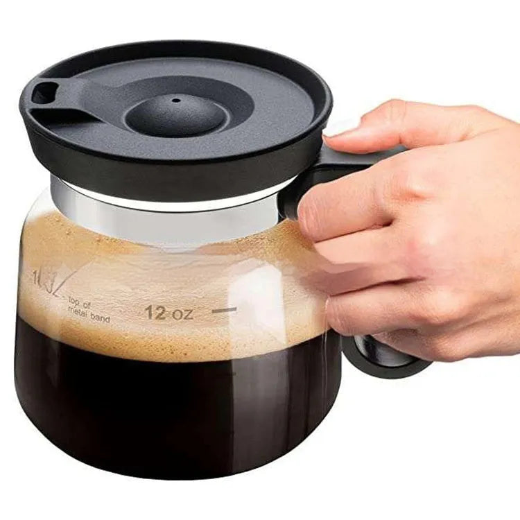 Transparent borosilicate glass French press coffee maker with stainless steel plunger and a black silicone cover.