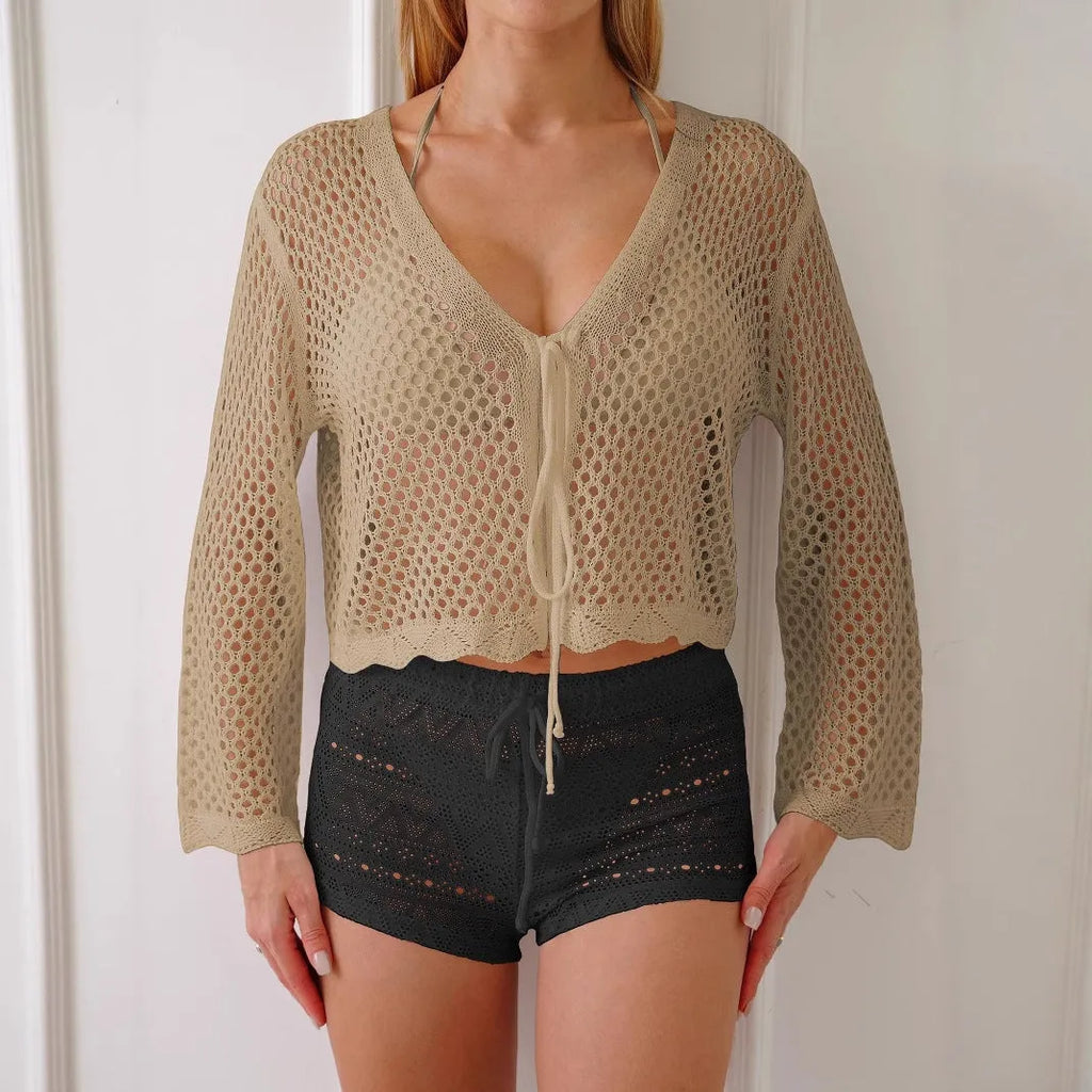 Light khaki women's cardigan blouse with bell sleeves and a cropped hem on a hanger.