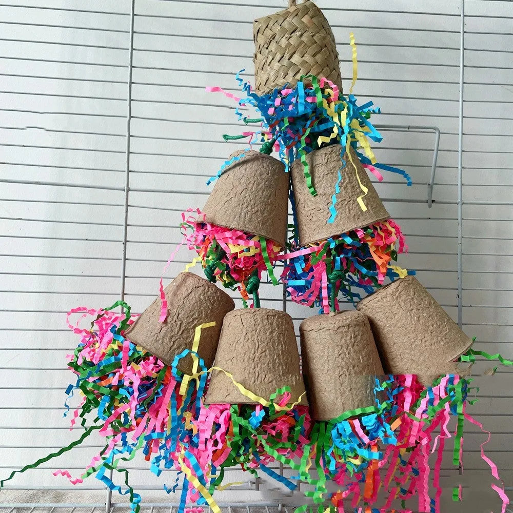 A wood-coloured parrot toy shaped like a paper cup with palm weaving texture, hanging from a string.