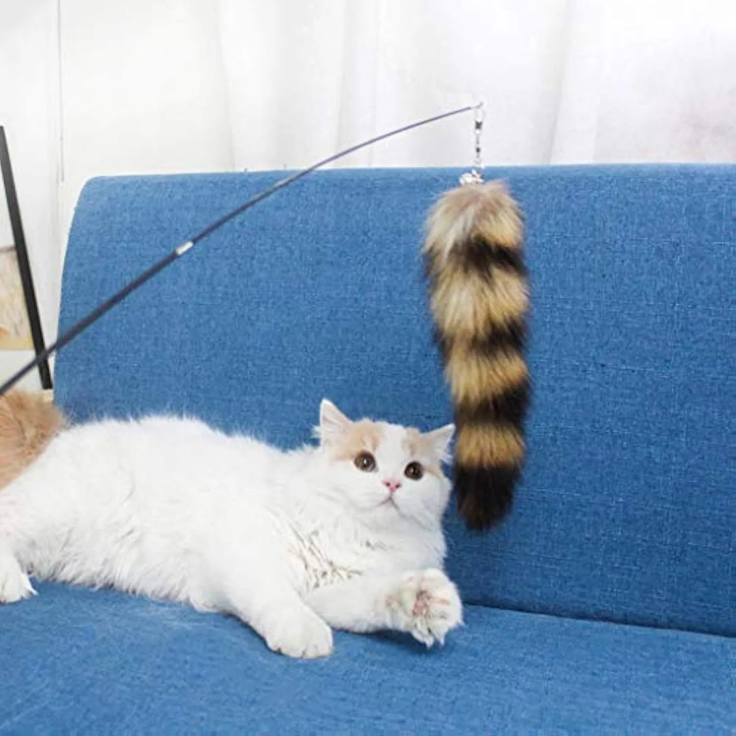 Black cat toy wand teaser with long elastic string stretched out for play.