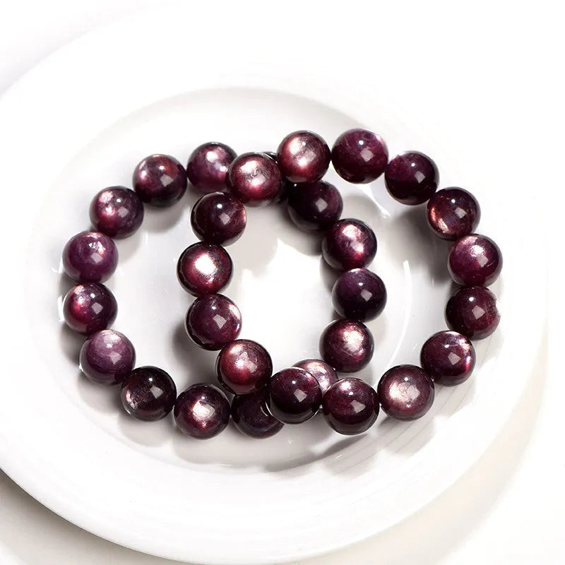 Purple lepidolite polished crystal round bead bracelet on a wrist, showing single circle design.