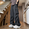 Men's plus size waterproof trousers in black, showing straight-leg fit and drawstring waist