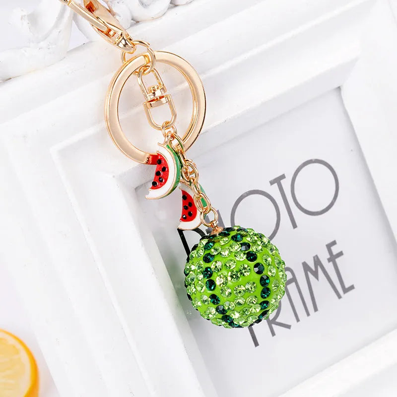 Green watermelon-shaped zinc alloy keychain measuring 12 centimetres