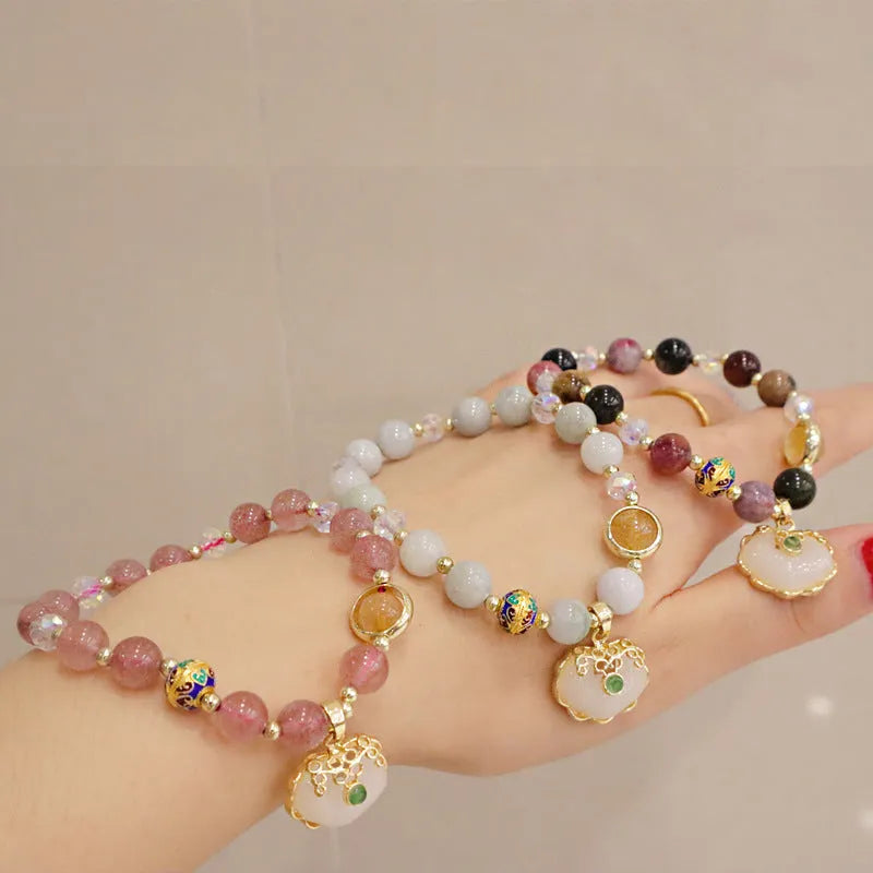 Geometric grey jade and metal ethnic bracelet for women on a wrist.