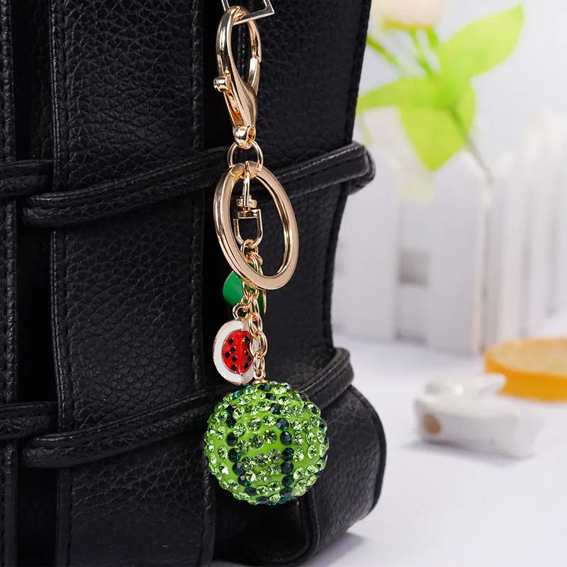 Green watermelon-shaped zinc alloy keychain measuring 12 centimetres
