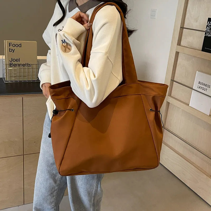 Folding Oxford cloth tote bag in multiple colour options showing compact storage design