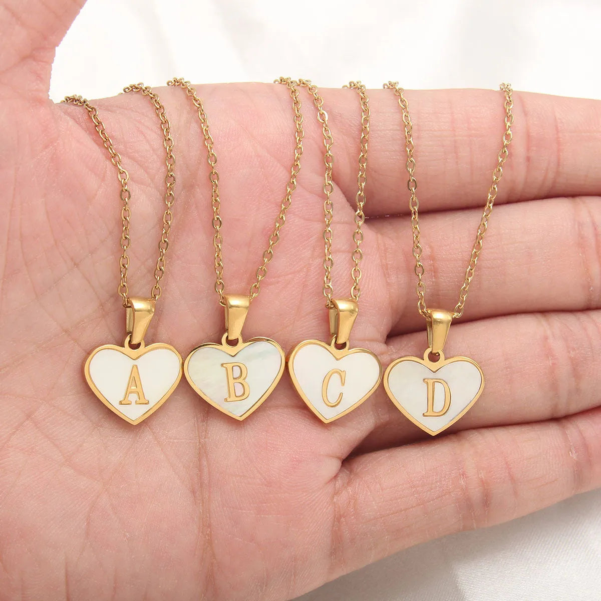 Gold plated heart necklace with white shell detail on an adjustable chain