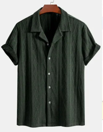 Man wearing a loose green short-sleeve cardigan-style beach shirt made from cotton and linen.