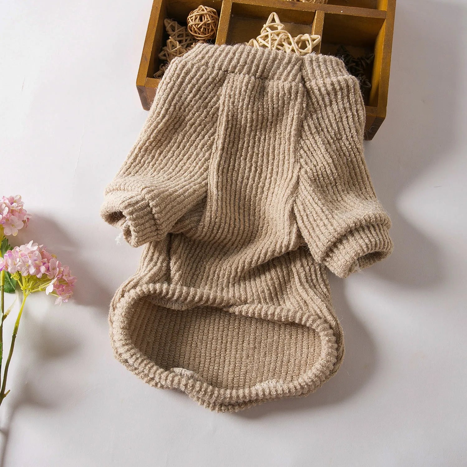 Brown cloth pullover sweater on a small dog, showing casual style.