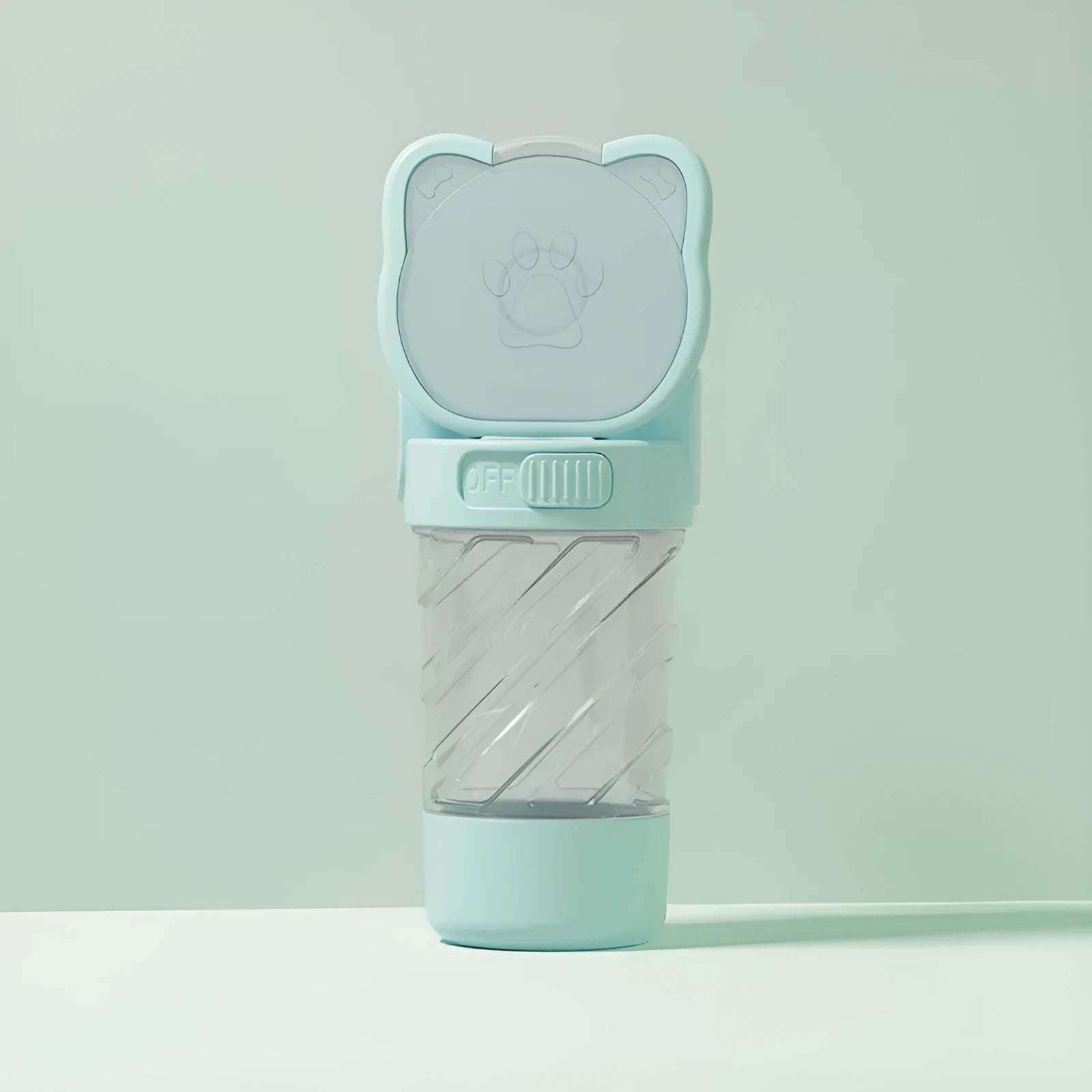 Green 3-in-1 portable pet water bottle with food pot and waste bag dispenser attached to a hand strap.