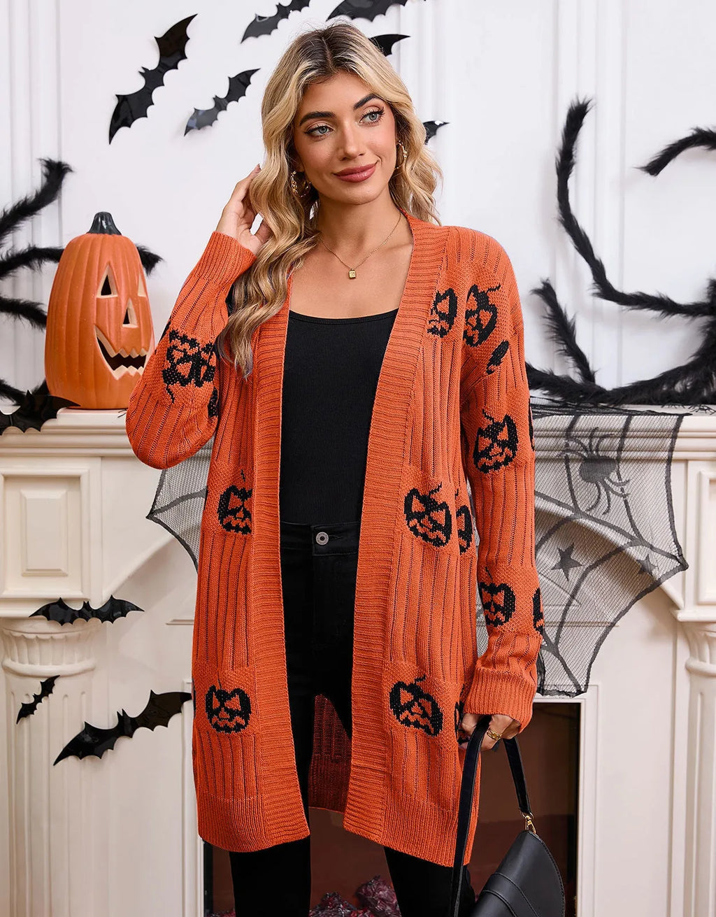 Women's black Halloween cardigan with orange pumpkin head jacquard knit pattern.