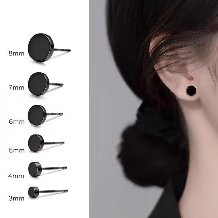 A pair of flat, round S999 sterling silver stud earrings on a plain background.
