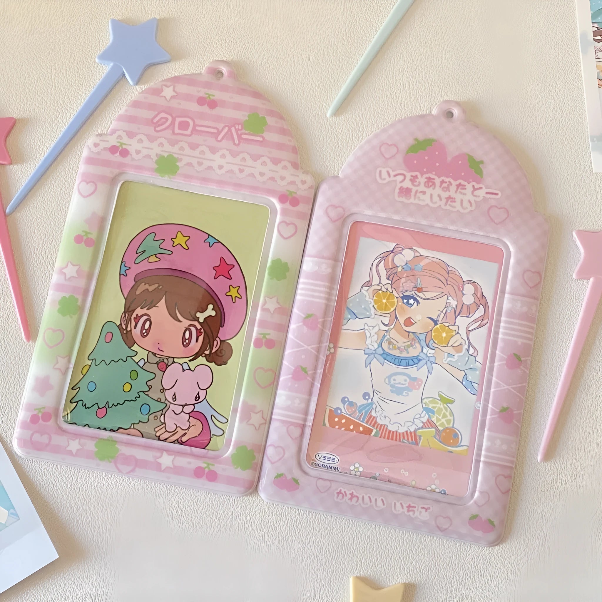 Cartoon strawberry or four-leaf clover PVC card holder measuring 7.6 by 13.6 centimetres.