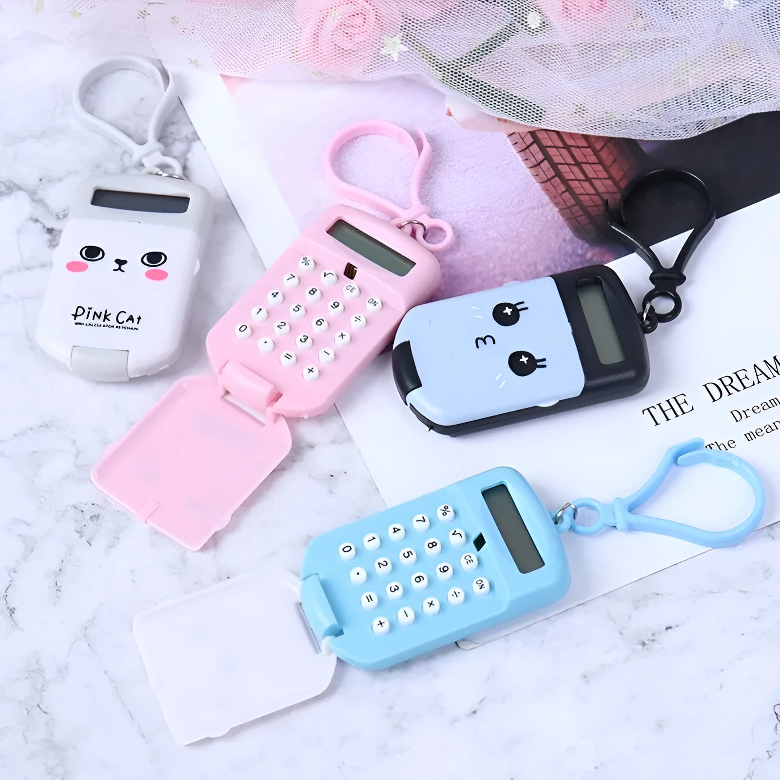 Creative cookie-shaped cute mini plastic calculator in black with key ring on a desk