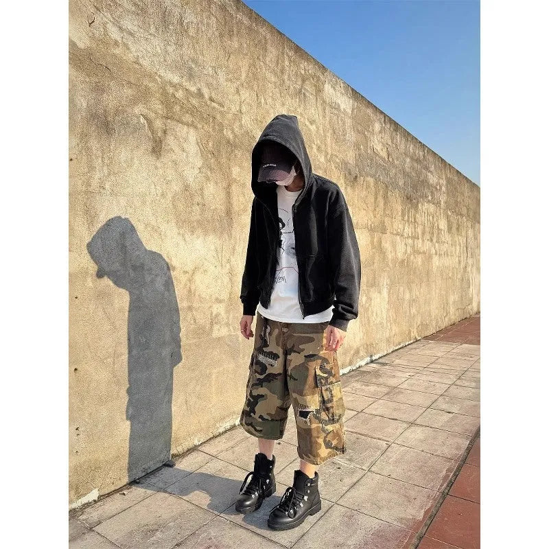 Men's loose fit camouflage patch ripped cropped jeans in a straight leg style.