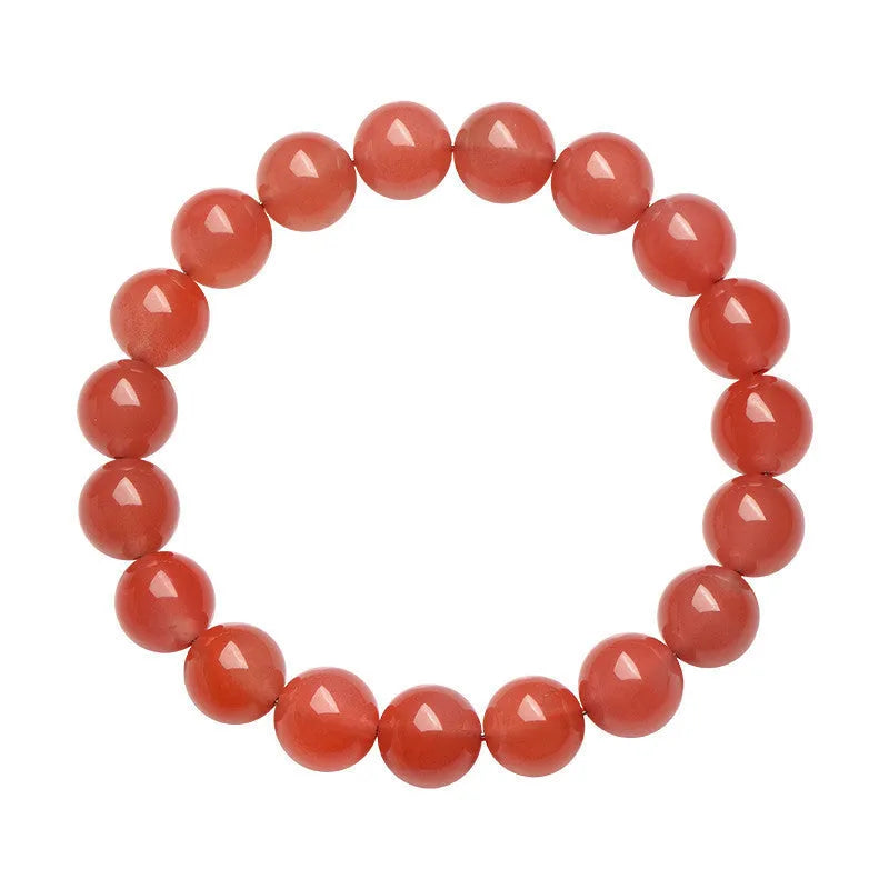 Natural cherry red agate bead bracelet on a wrist, showing polished stones and string construction.