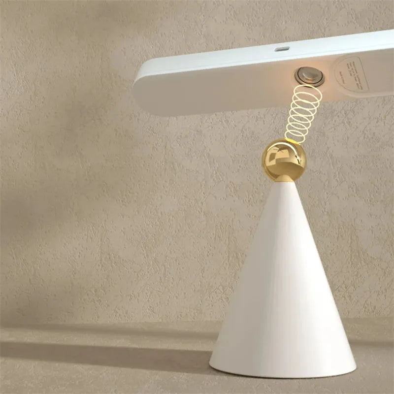 White geometric desk lamp with magnetic suction base and touch control on wooden desk