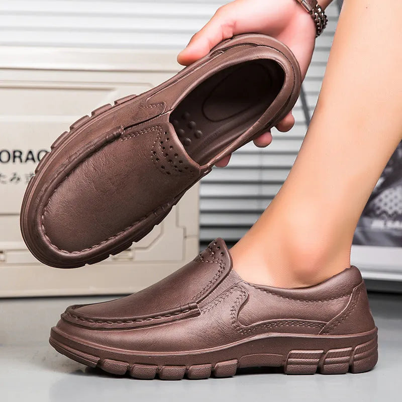 Men's black slip-on work shoes with waterproof platform sole and round toe design