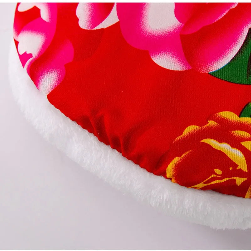 Red winter dog vest with plush lining, metal D-ring, and large floral peony pattern on a small dog