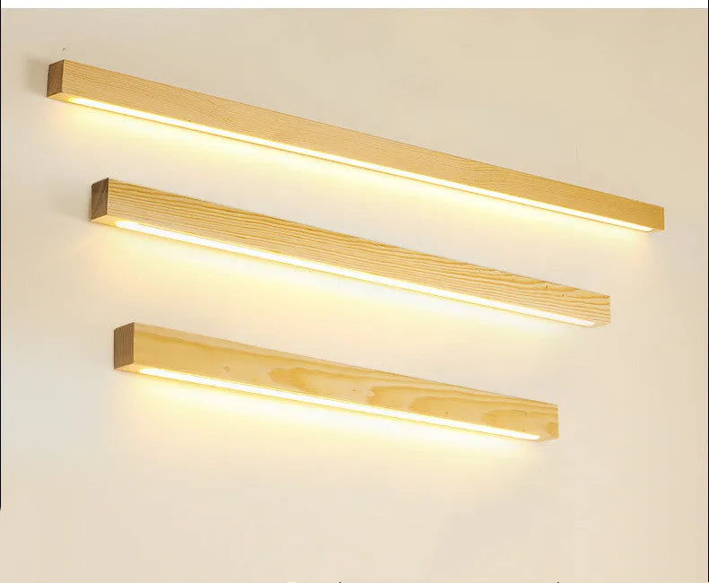 Walnut colour wooden log design LED strip wall lamp in three lengths on a modern wall.