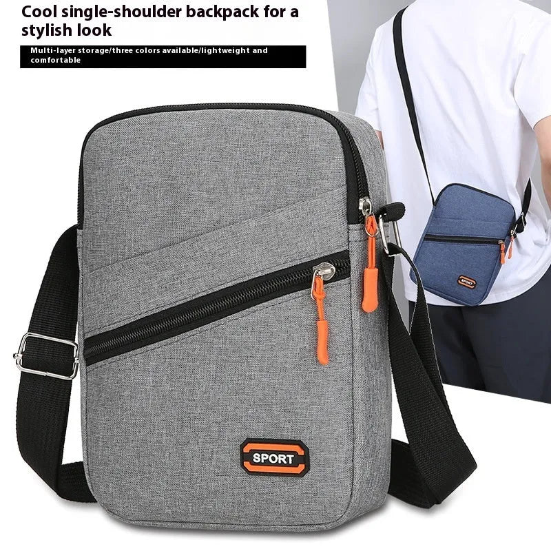 Oxford cloth crossbody commuter bag with contrast detailing in silver grey, black, or navy blue