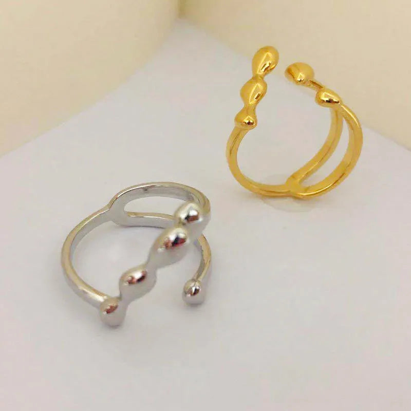 Brass opening ring with spherical elements in gold or silver colour for women's jewellery