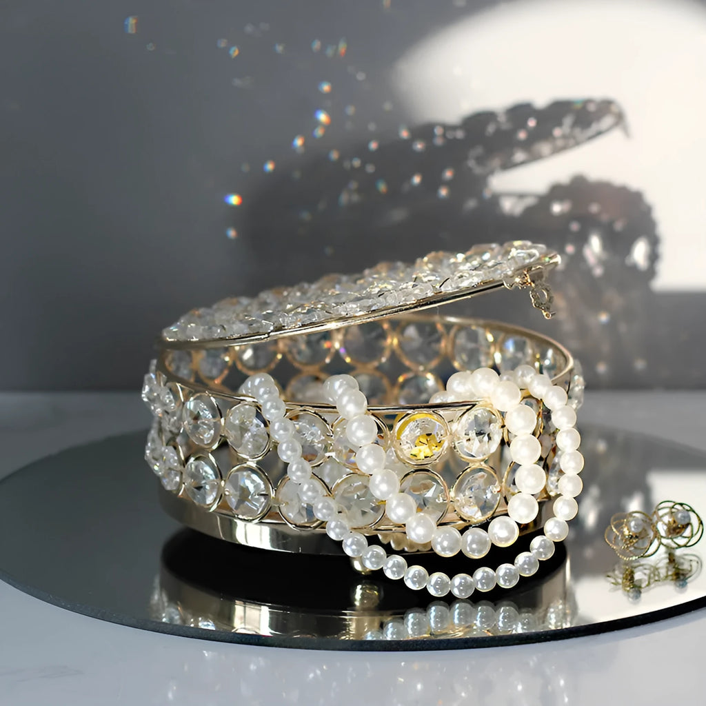 French gold metal jewelry box with a clear crystal glass front panel on display.